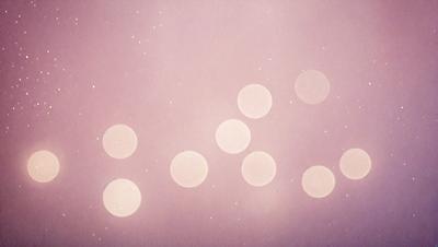 The primary subject of the image is a group of nine round objects, which are likely stars or planets, arranged in a circular pattern. The setting is a purple background, which adds a unique and artistic touch to the scene. The visual style appears to be a combination of a photo and digital art, creating a captivating and visually appealing image. The colors and mood of the image are predominantly purple, which gives it a calm and serene atmosphere.