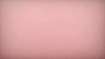 The primary subject of the image is a pink surface, which appears to be a piece of paper or a wall. The setting is a simple, uncluttered environment, with no visible background or backdrop. The visual style is a close-up of the pink surface, which gives the image a clean and minimalist appearance. The colors and mood of the image are predominantly pink, creating a warm and inviting atmosphere.