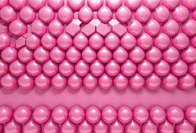 The primary subject of the image is a large pink wall with a pattern of pink and clear balls. The setting is a room with a pink background, and the visual style is a combination of photo and digital art. The dominant colors are pink and clear, creating a warm and inviting atmosphere.