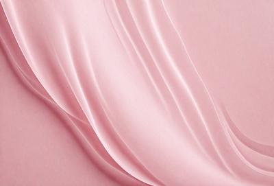 The primary subject of the image is a pink fabric, which is the main object, scene, or focus of the image. The setting or background is a pink surface, and the visual style is a close-up of the fabric. The colors and mood of the image are predominantly pink, creating a warm and inviting atmosphere.