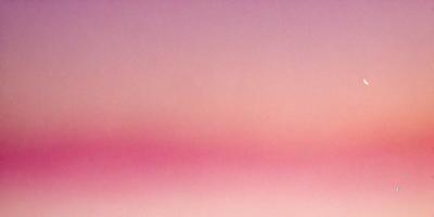 The primary subject of the image is a pink sky, which creates a serene and calming atmosphere. The setting is a cloudy sky, and the visual style appears to be a photo. The colors and mood of the image are predominantly pink, which adds a sense of warmth and tranquility to the scene.