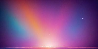 The primary subject of the image is a beautiful sunset, with the sun setting behind a cloud. The sky is a mix of purple and pink hues, creating a serene and picturesque scene. The setting/background features a cloudy sky, which adds depth and interest to the image. The visual style of the image is a photo, capturing the natural beauty of the sunset. The colors and mood of the image are predominantly purple and pink, evoking a sense of calmness and tranqu
