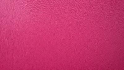 The primary subject of the image is a pink leather surface. The setting is a close-up of the leather, showcasing its texture and color. The visual style is a realistic representation of the leather, with no indication of digital art or illustration. The colors and mood of the image are predominantly pink, creating a warm and inviting atmosphere.