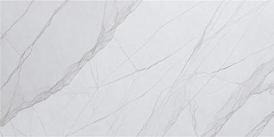 The primary subject of the image is a white marble wall with a pattern of thin, wavy lines. The setting is a room with a white background, and the visual style is a close-up of the marble wall. The colors and mood of the image are predominantly white, giving it a clean and elegant appearance.