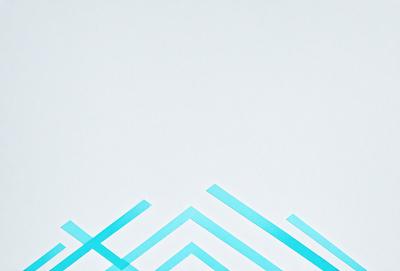The primary subject of the image is a white wall with a blue pattern on it. The setting is a room with a white background. The visual style is a patterned wallpaper, giving the room a modern and stylish appearance. The dominant colors are white and blue, creating a clean and calming atmosphere.