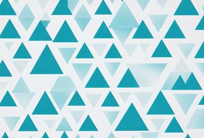The primary subject of the image is a pattern of blue triangles. The setting is a white background, which creates a contrast with the blue triangles. The visual style is a digital art or illustration, as the triangles are arranged in a geometric pattern. The dominant colors are blue and white, creating a calm and soothing atmosphere.
