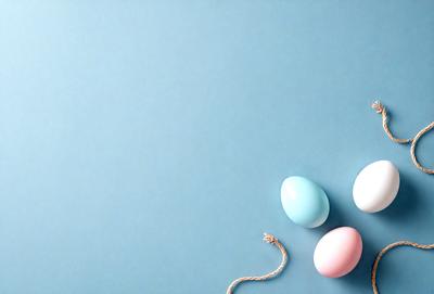 The primary subject of the image is a group of three eggs, each with a different color, sitting on a blue surface. The setting appears to be a studio or a controlled environment, as the eggs are placed on a table or a similar surface. The visual style of the image is a close-up, focusing on the eggs and their colors. The overall atmosphere of the image is calm and serene, with the eggs being the main focus of the scene.