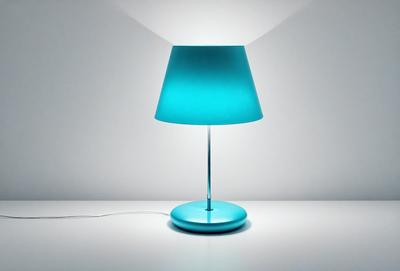 The primary subject of the image is a blue lamp with a white base, placed on a white table. The lamp is turned on, and its light illuminates the surrounding area. The setting appears to be a simple, minimalist environment, with the lamp being the main focus of the image. The visual style is a realistic representation of the lamp and its surroundings. The colors and mood of the image are predominantly white and blue, creating a calm and serene atmosphere.