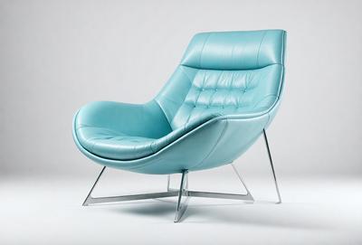 The primary subject of the image is a blue chair, which is the main object, scene, or focus of the image. The chair is placed on a white surface, which serves as the setting or background. The visual style of the image is a photo, capturing the chair in its natural environment. The dominant colors in the image are blue and white, creating a calm and soothing atmosphere.