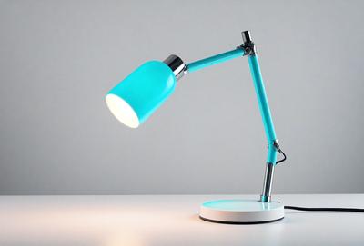 The primary subject of the image is a blue desk lamp with a white base. The lamp is turned on, and its light is shining brightly. The setting is a white table, and the visual style is a photo. The colors and mood of the image are predominantly blue and white, creating a clean and modern atmosphere.
