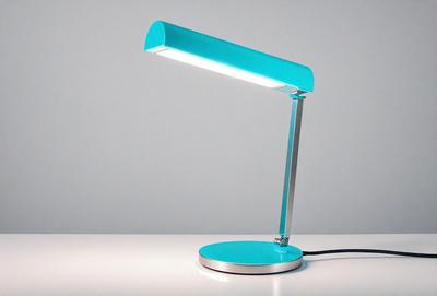 The primary subject of the image is a blue desk lamp with a light on. The lamp is placed on a white surface, which serves as the setting or background. The visual style of the image is a photo, capturing the lamp's light and color. The dominant colors in the image are blue and white, creating a calm and soothing atmosphere.