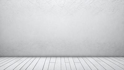The primary subject of the image is a white wall with a gray texture. The setting is a room with a white floor. The visual style is a photo, and the colors and mood are predominantly white and neutral.