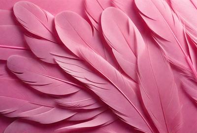 The primary subject of the image is a close-up of a pink feather. The setting is a pink background, which creates a visually striking contrast with the feather. The visual style is a combination of a photo and digital art, as the feather appears to be a part of a larger pink wing. The colors and mood of the image are predominantly pink, giving it a warm and vibrant atmosphere.