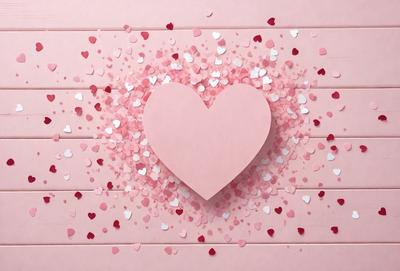 The primary subject of the image is a heart-shaped cutout made of pink paper. The heart is placed on a pink background, which is likely a wall or a table. The visual style of the image is a combination of photo and digital art, as it appears to be a close-up of the heart cutout. The colors and mood of the image are predominantly pink, which gives it a warm and romantic atmosphere.