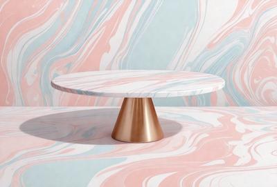 The primary subject of the image is a small, round, white and pink table with a gold base. The table is placed on a pink and blue marbled surface, which serves as the setting and background of the scene. The visual style of the image is a combination of photo and digital art, creating a unique and eye-catching presentation. The dominant colors of the scene are pink, blue, and white, with the gold base adding a touch of warmth and sophistication to the overall atmosphere.