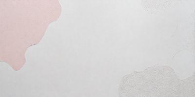 The primary subject of the image is a white wall with a few pink spots. The setting is a room with a white background. The visual style is a photo, and the colors and mood are predominantly white and pink.