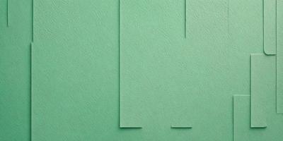 The primary subject of the image is a green piece of paper. The setting is a green background, which creates a contrast with the paper. The visual style is a close-up of the paper, showcasing its texture and color. The colors and mood of the image are predominantly green, giving it a calm and serene atmosphere.