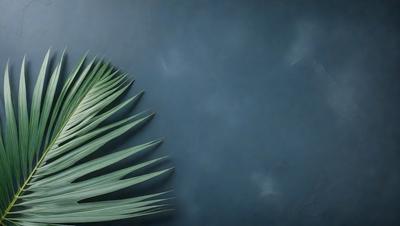 The primary subject of the image is a large green palm leaf. The leaf is prominently displayed against a blue wall, creating a striking contrast. The setting appears to be a room with a wall painted in a dark blue color. The visual style of the image is a close-up of the palm leaf, emphasizing its texture and details. The colors and mood of the image are predominantly blue and green, giving it a calm and serene atmosphere.