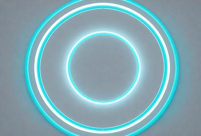 The primary subject of the image is a large, illuminated circle. The circle is blue and appears to be a light source, possibly a neon sign or a light fixture. The setting is a gray background, which contrasts with the bright blue circle. The visual style of the image is a close-up of the circle, emphasizing its shape and color. The overall atmosphere of the image is modern and futuristic, with the blue circle serving as a focal point.