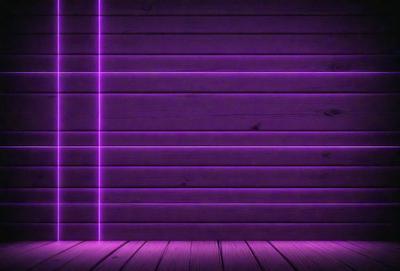 Purple wall, wooden floor, purple lighting.