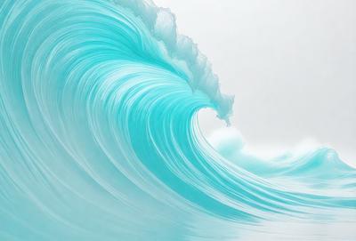 The primary subject of the image is a large, blue wave crashing onto the ocean floor. The wave is the main focus of the image, and it appears to be a natural occurrence. The setting is the ocean, with the wave crashing onto the ocean floor. The visual style of the image is a photo, capturing the beauty and power of the ocean. The dominant colors in the image are blue and white, creating a serene and calming atmosphere.