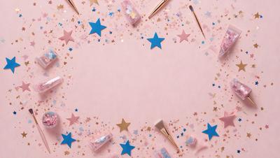 The primary subject of the image is a pink background with a star-shaped pattern. The setting is a table with a pink surface, and the visual style appears to be a combination of photo and digital art. The colors and mood of the image are predominantly pink and star-themed, creating a warm and playful atmosphere.