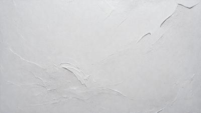 The primary subject of the image is a white wall with a smooth, textured surface. The setting is a room with a white background, which creates a clean and minimalist atmosphere. The visual style is a close-up of the wall, showcasing its texture and appearance. The colors in the image are predominantly white, which contributes to the calm and serene mood of the scene.