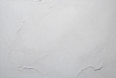 The primary subject of the image is a white wall with a few white paint splatters on it. The setting is a room with a white background. The visual style is a close-up of the wall, and the colors and mood are predominantly white, giving the image a clean and minimalist appearance.