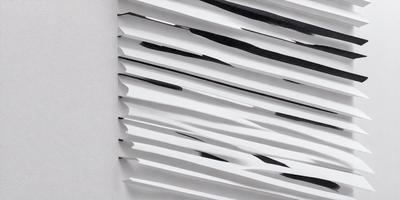 The primary subject of the image is a white wall with a pattern of black and white stripes. The setting is a room with a white background, and the visual style appears to be a combination of a photo and a drawing. The dominant colors are white and black, creating a clean and modern atmosphere.