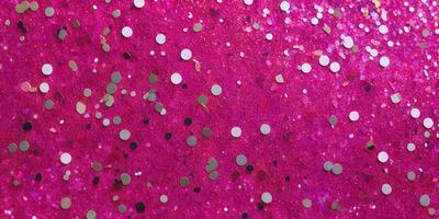 The primary subject of the image is a close-up of a pink background with a pattern of glittery gold stars. The setting is a pink surface, and the visual style appears to be a combination of a photo and digital art. The dominant colors are pink and gold, creating a warm and vibrant atmosphere.
