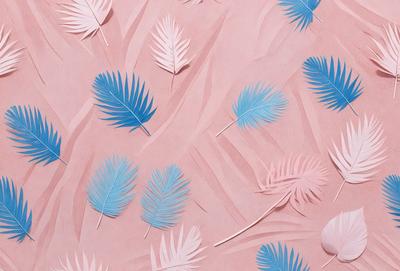 The primary subject of the image is a collection of blue and pink feathers arranged on a pink background. The feathers are scattered across the surface, creating a visually appealing and artistic display. The setting appears to be a creative and imaginative environment, possibly a work of digital art or illustration. The colors and mood of the image are predominantly pink and blue, giving it a warm and inviting atmosphere.