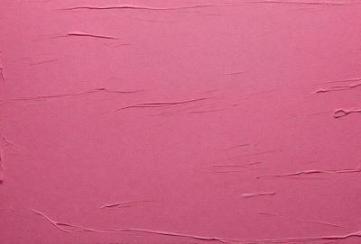 The primary subject of the image is a pink wall with a textured surface. The setting is a room with a pink background. The visual style is a close-up of the pink wall, which gives a sense of depth and texture. The colors and mood of the image are predominantly pink, creating a warm and inviting atmosphere.