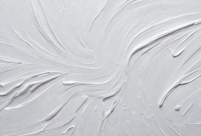 The primary subject of the image is a white, swirling, and curving design on a white background. The setting appears to be a canvas or a white wall, with the design possibly being a painting or a digital artwork. The visual style suggests that the image is a creative and artistic representation, possibly with a focus on texture or pattern. The colors and mood of the image are predominantly white, giving it a clean and minimalist appearance.