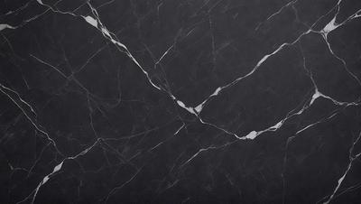 The primary subject of the image is a black marble countertop. The setting is a kitchen, with the countertop being the main focus of the scene. The visual style is a close-up of the marble countertop, showcasing its texture and pattern. The colors and mood of the image are predominantly dark, with the black marble countertop being the main source of contrast.