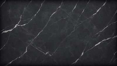 The primary subject of the image is a black marble countertop. The setting is a kitchen, with the countertop being the main focus of the scene. The visual style is a close-up of the marble countertop, showcasing its texture and pattern. The colors and mood of the image are predominantly dark, with the black marble providing a striking contrast against the lighter background.