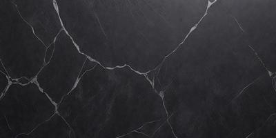 The primary subject of the image is a black marble wall with a cracked pattern. The setting is a dark room, and the visual style is a close-up of the marble wall. The colors and mood of the image are dark and moody, with the black marble wall being the main focus.