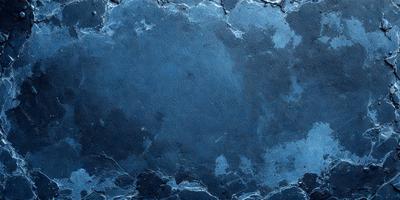 The primary subject of the image is a blue surface, which appears to be a piece of art or a decorative item. The setting is a dark room, and the visual style is a close-up of the blue surface. The colors and mood of the image are predominantly dark and moody, with the blue surface being the main focal point.