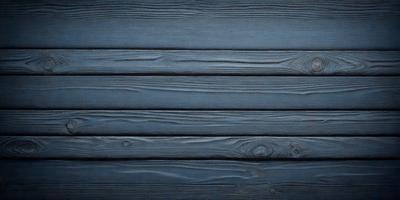 The primary subject of the image is a wooden wall with a blue background. The setting is a room with a wooden floor. The visual style is a photo of a wooden wall. The dominant colors are blue and brown, creating a calm and natural atmosphere.