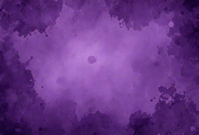 The primary subject of the image is a purple background with a few black spots. The setting appears to be a space or an abstract environment. The visual style is a combination of a photo and digital art, creating a unique and intriguing appearance. The dominant colors are purple and black, giving the image a moody and mysterious atmosphere.