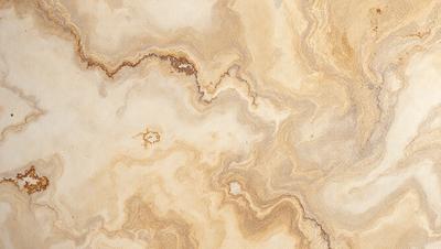 The image features a marble-like surface with a pattern of swirls and curves. The primary subject is the marble-like material, which is the setting and background of the image. The visual style is a close-up of the marble, showcasing its intricate patterns. The colors and mood of the image are predominantly earthy tones, giving it a natural and elegant appearance.
