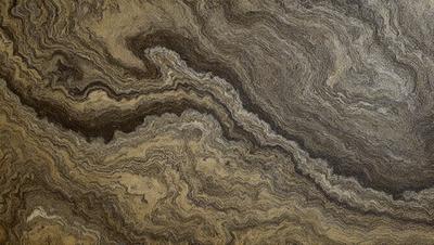 The primary subject of the image is a close-up of a wooden surface, possibly a table or a piece of wood. The setting is indoors, with the wooden surface being the main focus of the image. The visual style appears to be a close-up of a textured surface, possibly a piece of wood or a table. The colors and mood of the image are predominantly brown, giving it a warm and natural atmosphere.