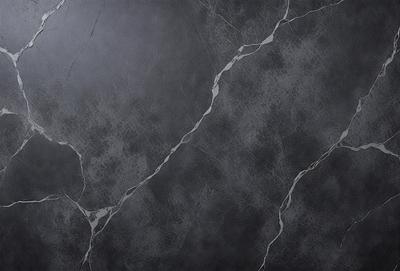 The primary subject of the image is a marble wall with a patterned texture. The setting is a room with a gray background. The visual style is a close-up of the marble wall, showcasing its unique texture. The colors and mood of the image are predominantly gray, giving it a sophisticated and elegant appearance.