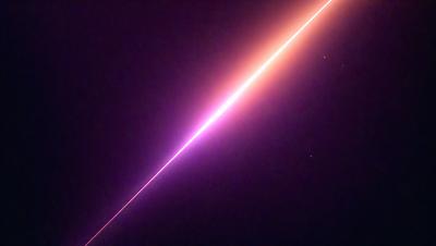 The image features a purple light streak in the sky, possibly a meteor or a shooting star. The sky is dark, and the purple light stands out against the black background. The visual style of the image suggests that it could be a photo or a digital art piece, capturing the beauty of the purple light in the night sky. The colors and mood of the image evoke a sense of wonder and awe, as the purple light creates a striking contrast against the dark background.