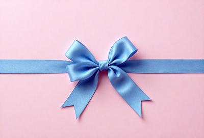 The primary subject of the image is a blue bow with a white center, which is placed on a pink background. The visual style of the image is a close-up of the bow, showcasing its details. The colors and mood of the image are predominantly pink and blue, creating a warm and inviting atmosphere.