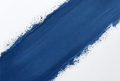 The primary subject of the image is a blue paint splatter on a white surface. The setting is a white wall, and the visual style appears to be a close-up of the paint splatter. The dominant colors are blue and white, creating a calm and serene atmosphere.