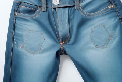 The primary subject of the image is a pair of blue jeans. The setting is a white background, and the visual style is a close-up of the jeans. The jeans are blue and have a denim texture. The overall atmosphere is casual and relaxed.