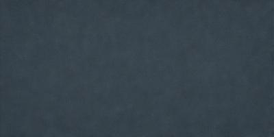 The primary subject of the image is a large, dark gray surface. The setting is a dark room, and the visual style is a close-up of the gray surface. The colors and mood of the image are predominantly dark and moody, with the gray surface being the main focus.