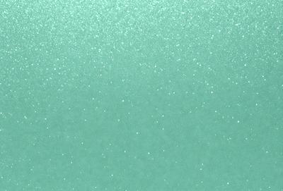 The primary subject of the image is a close-up of a green surface, possibly a wall or a piece of fabric. The setting appears to be indoors, with the green surface being the main focus of the image. The visual style is a close-up, which emphasizes the details of the green surface. The colors in the image are predominantly green, creating a calm and soothing atmosphere.