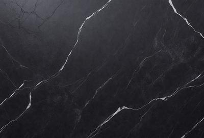 The primary subject of the image is a black marble countertop. The setting is a kitchen, with the countertop being the main focus of the scene. The visual style is a close-up of the marble countertop, showcasing its texture and details. The colors and mood of the image are predominantly dark and moody, with the black marble countertop being the main source of contrast and visual interest.
