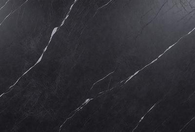 The primary subject of the image is a black marble countertop. The setting is a kitchen, with the countertop being the main focus of the scene. The visual style is a close-up of the marble countertop, showcasing its texture and details. The colors and mood of the image are predominantly dark, with the black marble countertop being the main source of contrast and visual interest.